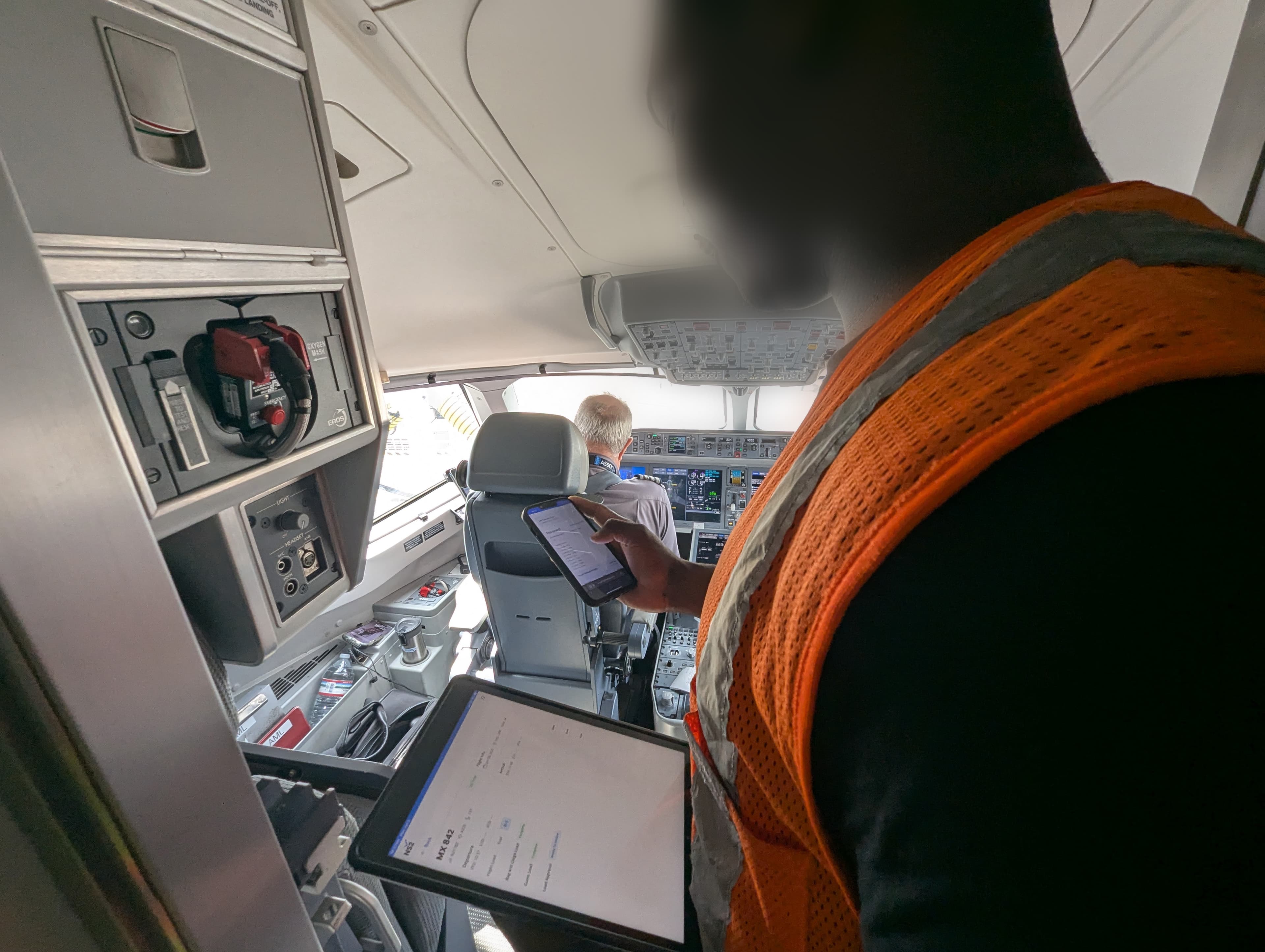 Pilot reviewing load sheet in the cockpit of an aircraft